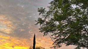 A swimming pool with lounge chairs, surrounded by a fence, and a building with a tiled roof in the background. - Prestigous Location within LBUSD. Mid to Long Term Discounts. Views of Foothills (Aliso Viejo)