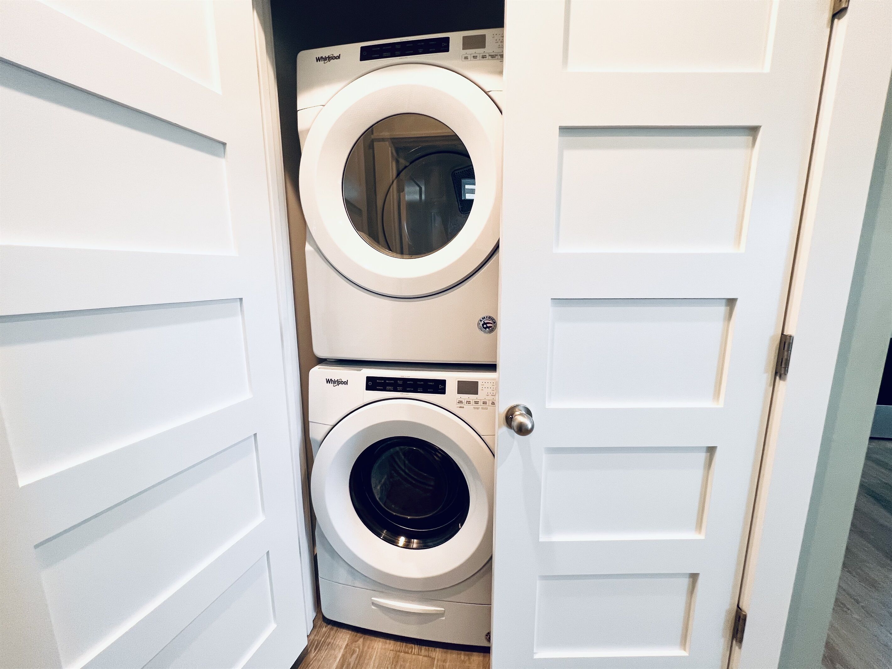 A laundry room with two stacked front-loading washing machines.