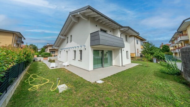 A modern two-story house with a flat roof, large windows, and a covered patio area. - La Casa di Antonietta (Udine)