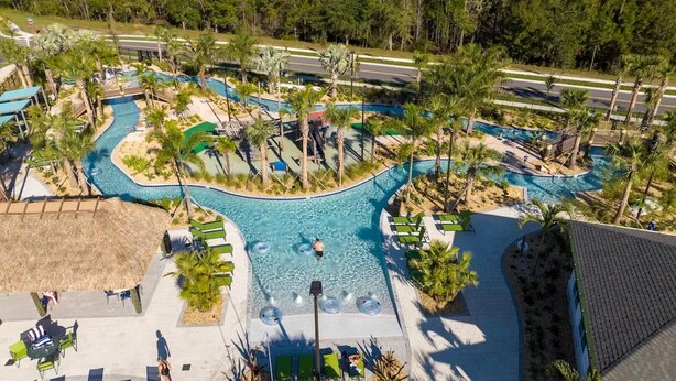 An aerial view of a resort with multiple swimming pools, palm trees, and lounge areas. - Gorgeus HOUSE Near Disney & FREE water park 4963 (Kissimmee)