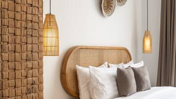 A modern bedroom with a wooden headboard, white bedding, and woven wall decor.