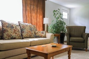 TV, fireplace - Riverfront Haven with Hot Tub and Dock (Traverse City)