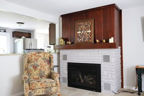 TV, fireplace - Riverfront Haven with Hot Tub and Dock (Traverse City)