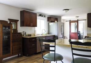 Fridge, microwave, oven, stovetop - Riverfront Haven with Hot Tub and Dock (Traverse City)