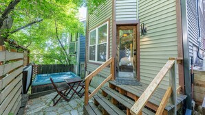 A backyard with a hot tub, wooden deck, and a wooden fence. - Old Town Park City Vacation Home with Private Hot Tub, Walk to Main St or Skiing (Park City)