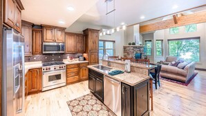 A spacious kitchen with wooden cabinets, stainless steel appliances, and a large island. - Old Town Park City Vacation Home with Private Hot Tub, Walk to Main St or Skiing (Park City)