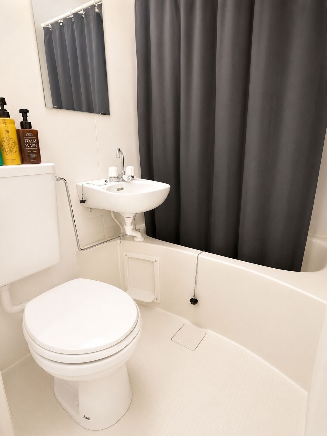 A bathroom with a toilet, sink, and bathtub.