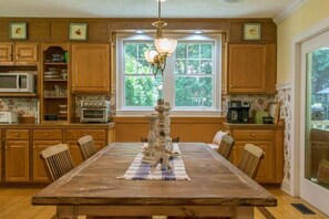 Enjoy meals and social gatherings in this well-equipped kitchen with a central island and ample dining space.
