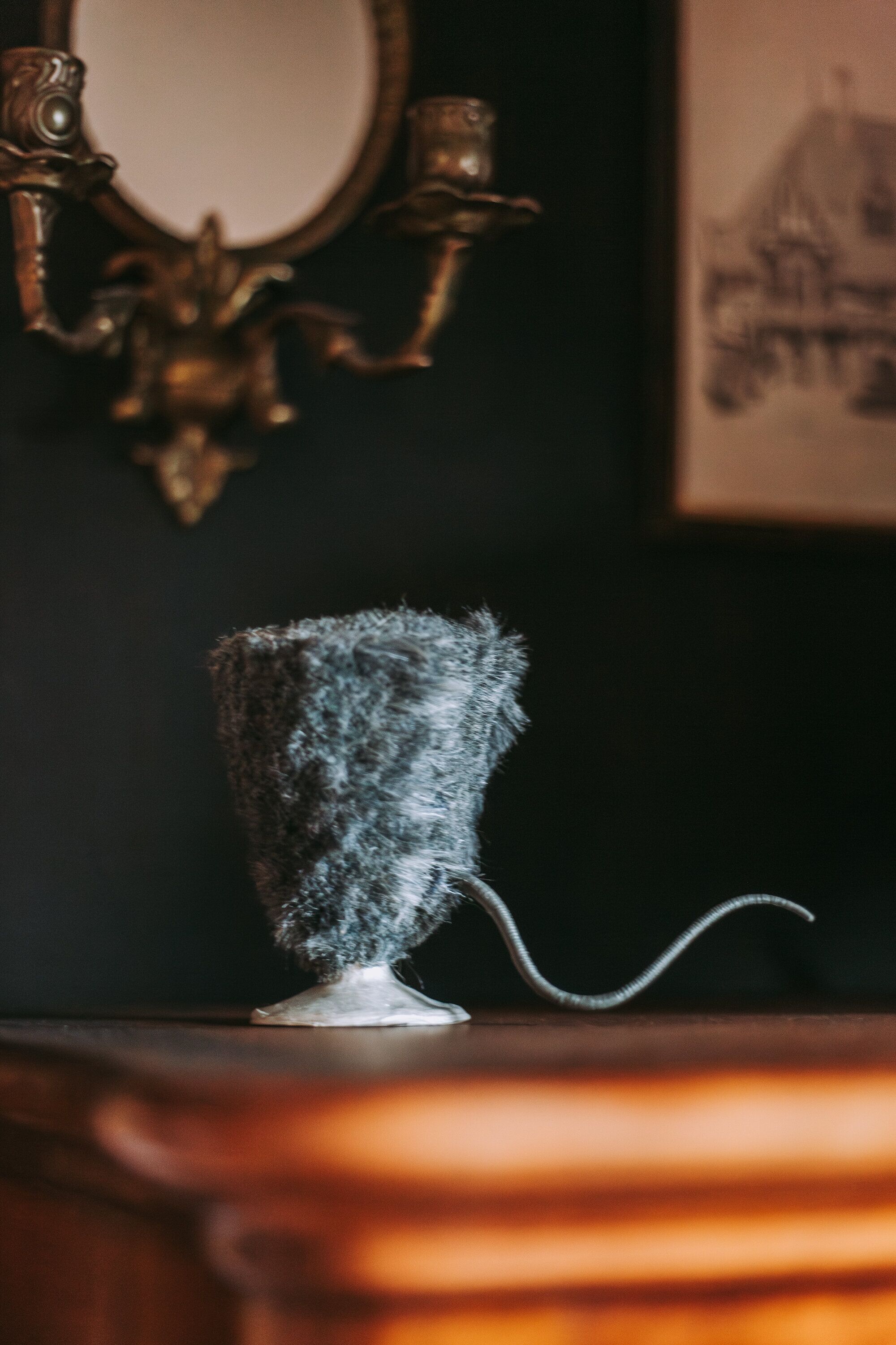 A vintage-style lamp with a textured shade on a wooden surface.