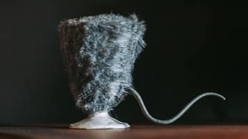 A vintage-style lamp with a textured shade on a wooden surface.