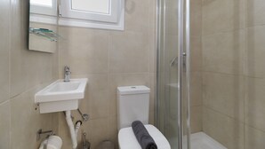 A bathroom with a sink, toilet, and glass shower enclosure. - M2 Room with Wi-Fi and Air Conditioning (Lefkada)