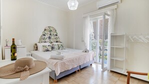 A bedroom with a bed, a hanging light fixture, a wardrobe, and a view of the outdoors. - 'M3 Room' with Wi-Fi and Air Conditioning (Lefkada)