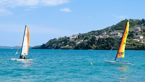 Two sailboats on a calm sea with a hilly coastline in the background. - 'M3 Room' with Wi-Fi and Air Conditioning (Lefkada)