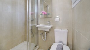 A bathroom with a glass shower enclosure, a sink, a toilet, and a mirror. - 'M3 Room' with Wi-Fi and Air Conditioning (Lefkada)