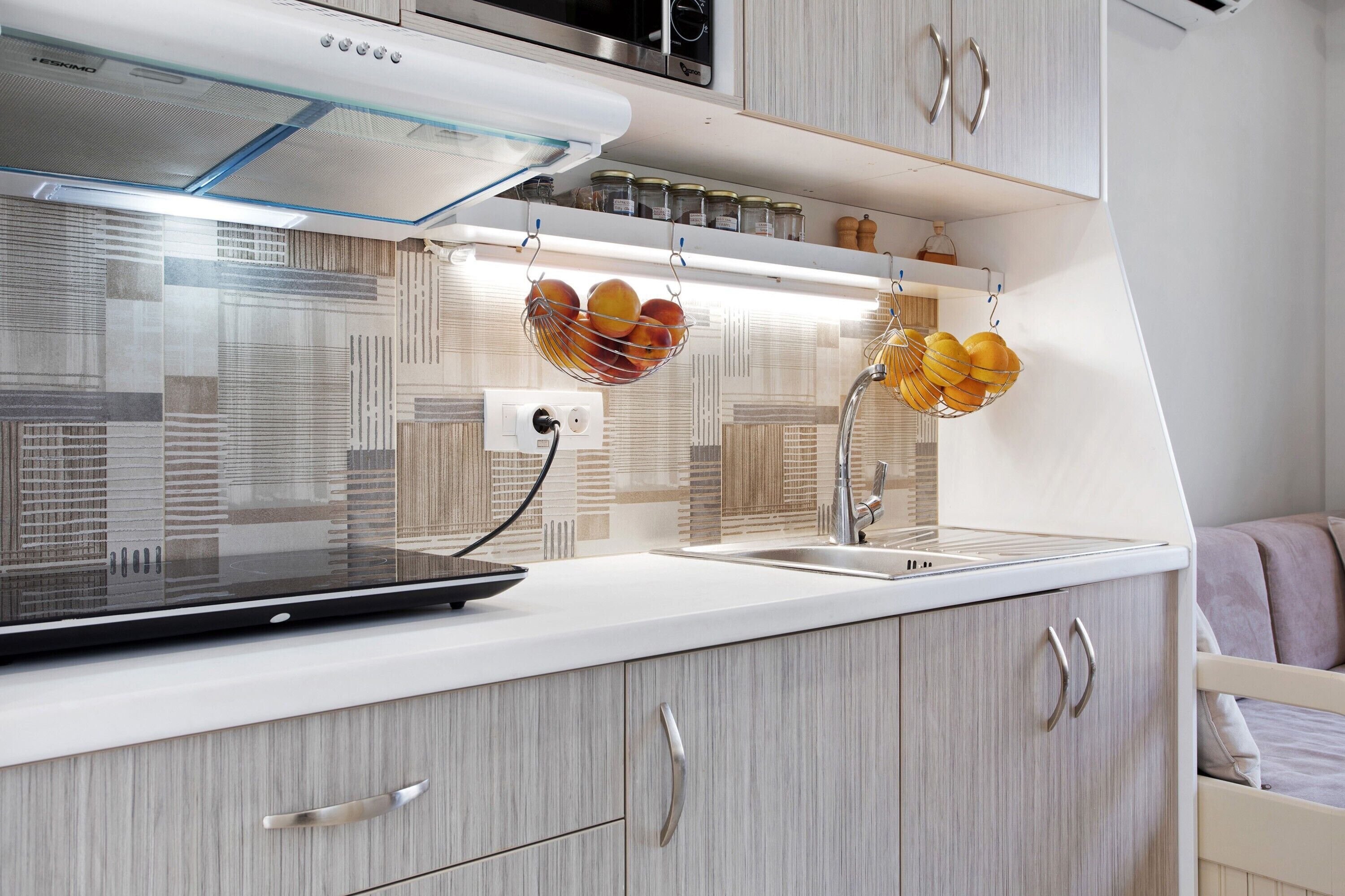 A modern kitchen with a built-in stove, a sink, and a countertop.
