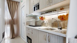 A modern kitchen with a microwave, oven, and sink. - Holiday Apartment "Casa Doppia 2" with Sea View, Balcony & Wi-Fi (Zakynthos)