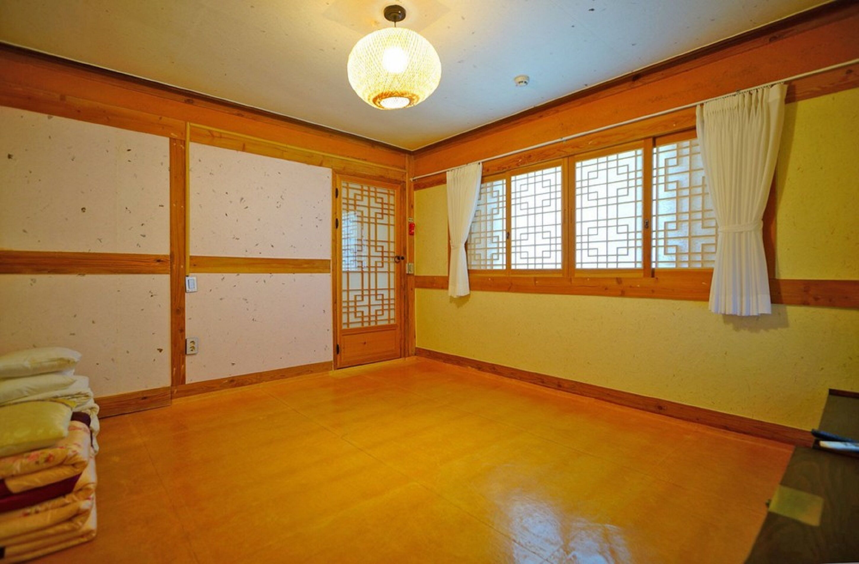 A traditional Japanese room with tatami flooring, sliding doors, and a shoji screen.