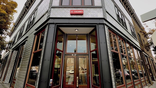 A corner building with a "NO VACANCY" sign, a "Linch Hotel" sign, and a "Linch Hotel" doormat. - The Ruby Peak Condo is part of the historic Litch Hotel (Enterprise)