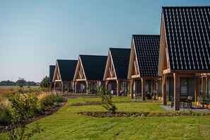 A row of modern, single-story buildings with sloped roofs, likely part of a resort or hotel. - EuroParcs Cadzand (Cadzand-Bad)