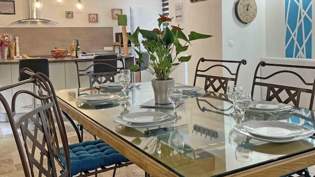 A dining area with a glass table, metal chairs, and a potted plant. - Old house - 8 guests (Réveillon)