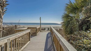 A wooden boardwalk leading to a beach with clear skies. - Direct Oceanfront Views,Pools Caravelle,HIGH Floor (Myrtle Beach)