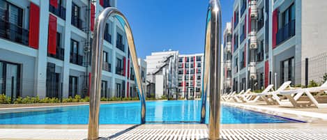 Seasonal outdoor pool, open 8:30 AM to 8:00 PM, pool umbrellas