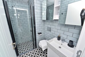 Shower, rainfall showerhead, hair dryer, towels