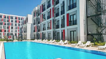 Seasonal outdoor pool, open 8:30 AM to 8:00 PM, pool umbrellas