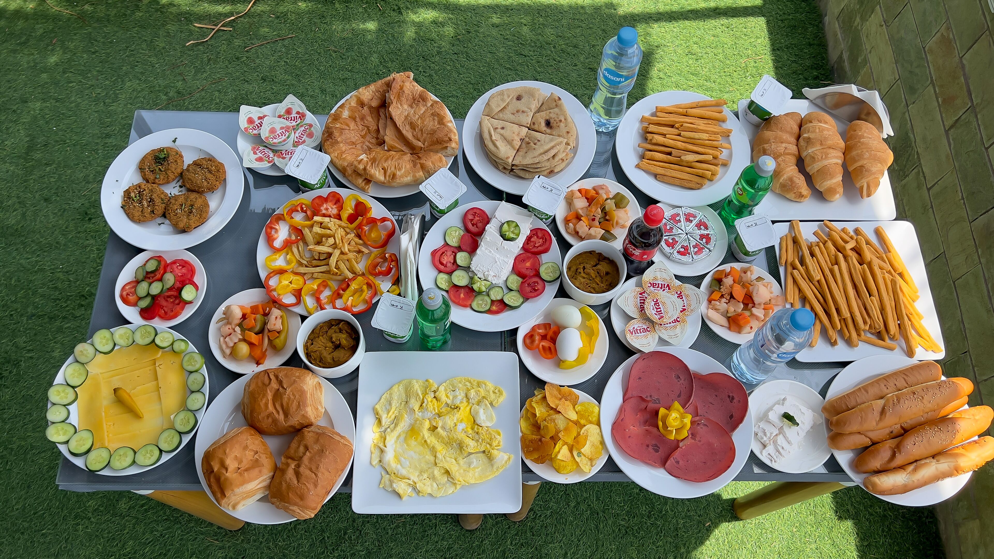 A table with various food items including bread, eggs, and vegetables.