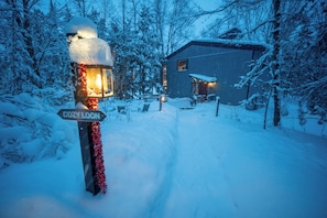A snow-covered path leading to a house with a sign reading "COZY LOON." - Cozy Loon Cabin in Namakagon on Little Bass Lake (Cable)