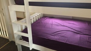 A bunk bed with a purple mattress and white frame. - A wonderful house share: can accommodate up to 15 friends and family.  (Nottingham)