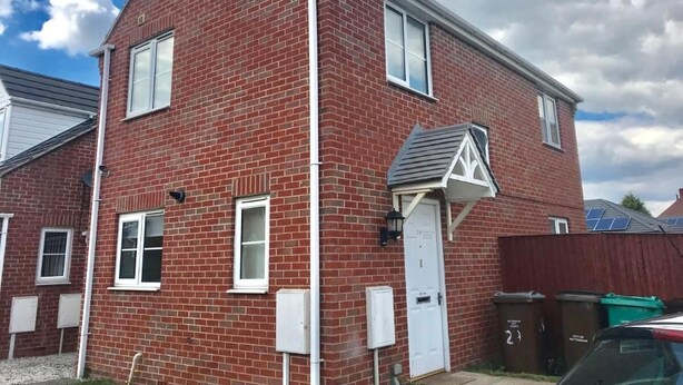 A red brick house with a white door, windows, and a small porch. - A wonderful house share: can accommodate up to 15 friends and family.  (Nottingham)