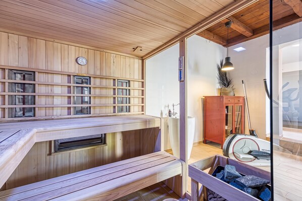 A sauna with wooden benches and a glass partition. - Hedonia Estate /w Sauna and Jacuzzi Near Varazdin (Petrijanec)