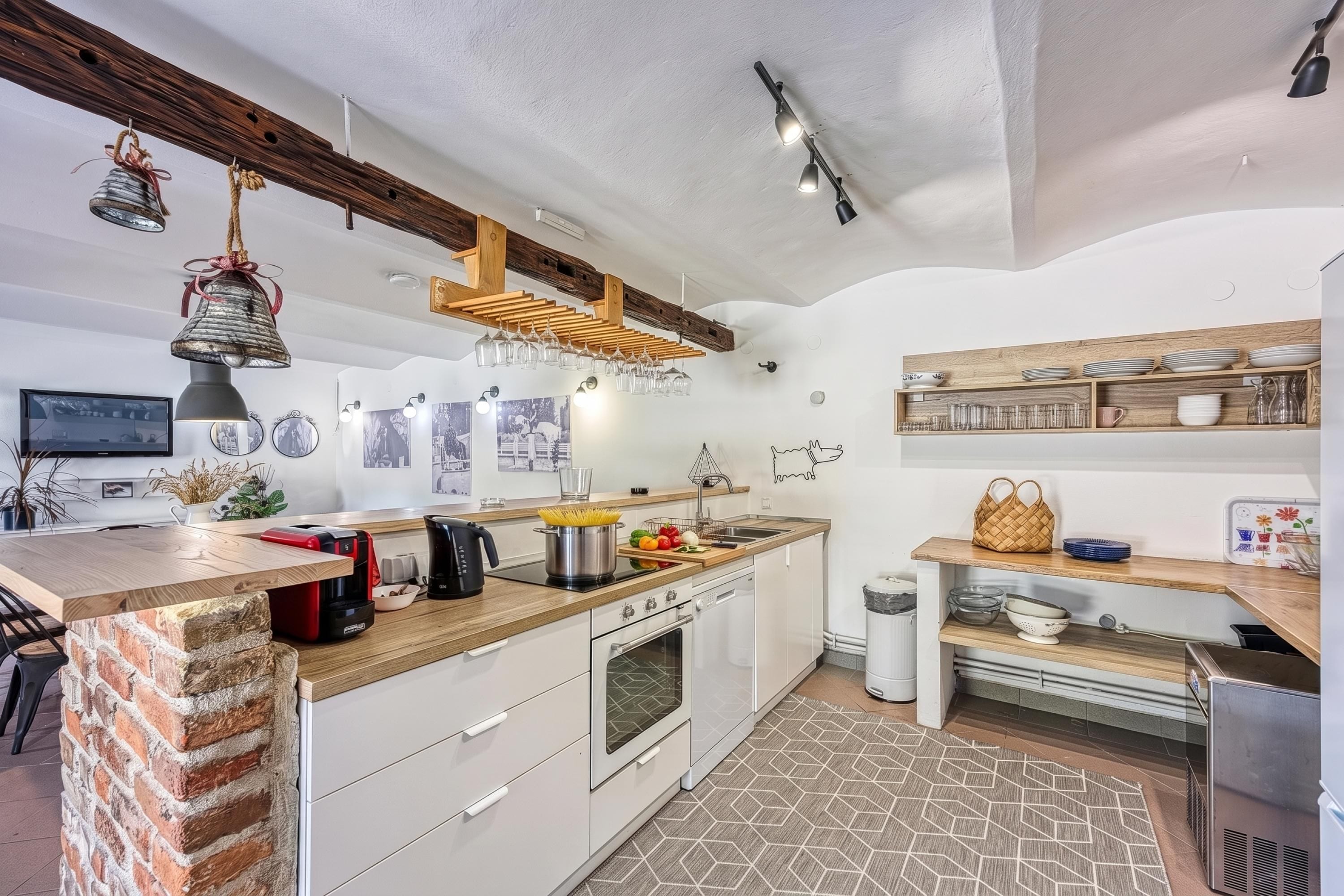 A modern kitchen with a wooden island, built-in appliances, and a rustic ceiling.