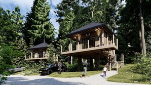 A wooden cabin with a balcony, surrounded by trees. - EuroParcs Ossiacher See (Ossiach)
