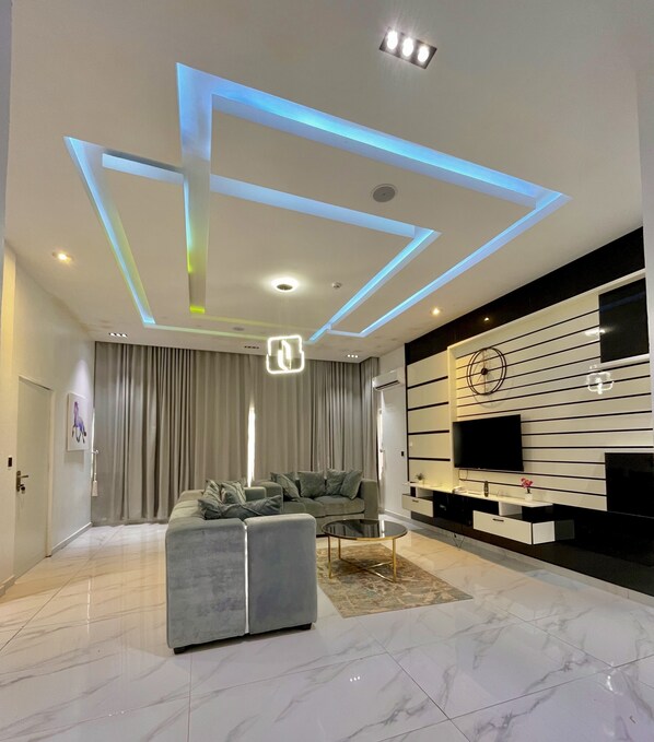 Family Suite, 2 Bedrooms, City View | Living area | Flat-screen TV, video game console, Netflix, DVD player - Lisa Suites (Abuja)