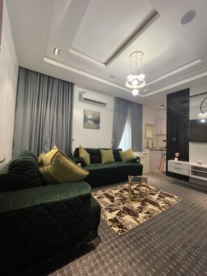 Comfort Apartment, 1 Bedroom | Living area | Flat-screen TV, video-game console, Netflix, DVD player - Lisa Suites (Abuja)