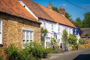 Traditional English pub with a classic exterior and outdoor seating area.