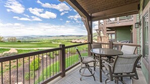A covered outdoor area with a table and chairs, overlooking a golf course and distant mountains. - Perfect location! Come and see (Park City)