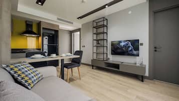 Deluxe Suite, River View | Living area | 82-cm Smart TV with satellite channels