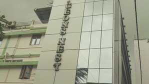 A hotel sign with the name "HOTEL DIBONG NEST" on a modern building. - Hotel Pigeons Nest (Port Blair)
