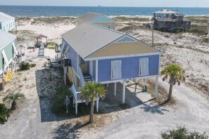 A beachfront house with a covered patio, a small deck, and a view of the ocean. - 3BR/2BA Fort Morgan Home | Sleeps 8 | Gulf Views & Bunkroom Fun (Gulf Shores)
