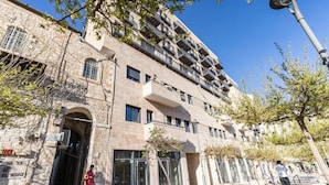 A multi-story building with a stone facade, large windows, and a modern entrance. - Luxury 3 BDR  In The Heart Of Jerusalem By Isrentals (Jerusalem)