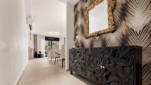 A modern interior with a black console table, a large mirror with an ornate frame, and a patterned wall. - Luxury 3 BDR  In The Heart Of Jerusalem By Isrentals (Jerusalem)