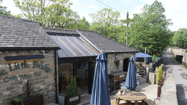 A stone building with a sign reading "The Little Bridge Cafe Wine Bar." - Idyllic cottage in Slaithwaite, stunning views, heart of the countryside (Upper Holme)