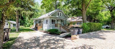 A single-story house with a front porch, a covered entryway, and a small front yard.