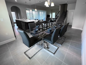 A modern kitchen with a dining area.