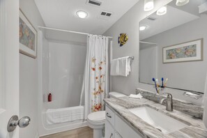 A modern bathroom with a shower, toilet, and sink. - Stunning Oceanfront Condo With Resort Amenities 3 Bedroom Condo by RedAwning (Orange Beach)