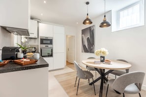 Enjoy meals in the spacious kitchen with a central island, oven, and dining table.