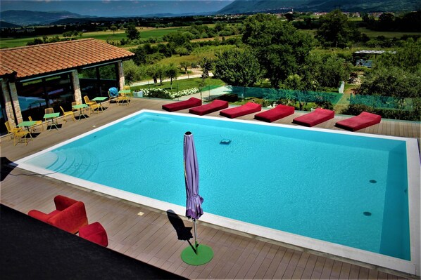 Seasonal outdoor pool, pool umbrellas, pool loungers
